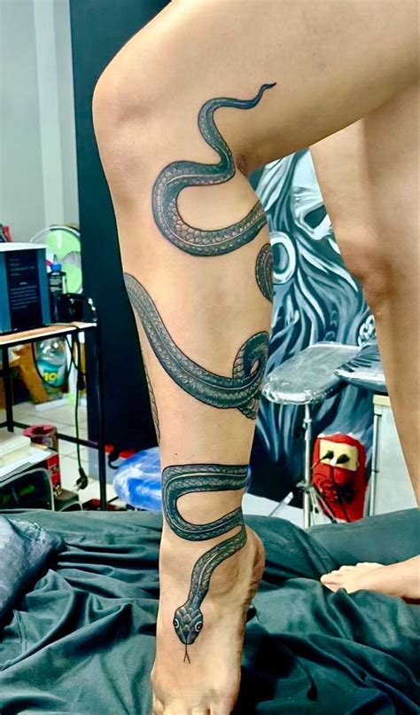 snake wrapped around leg tattoo|Unique Snake Wrapped Leg Tattoo Designs